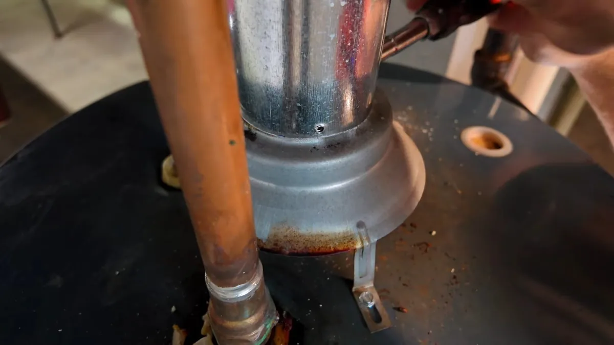 Metal vent connector and a copper supply line fitted to the top of a gas water heater